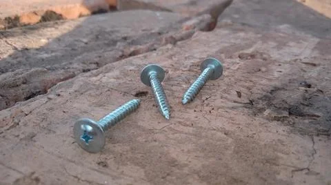 Self-tapping screws on bricks Stock Photos