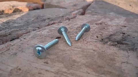 Self-tapping screws on bricks Stock Photos