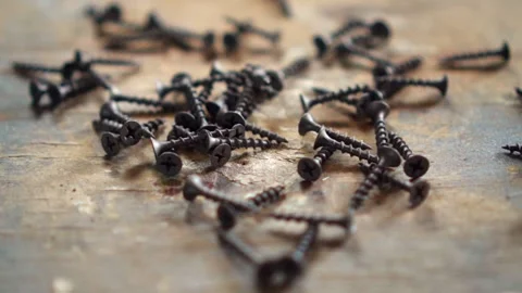 Self-tapping screws fall on a tree. Close-up. Slow motion. Stock Footage 248956116