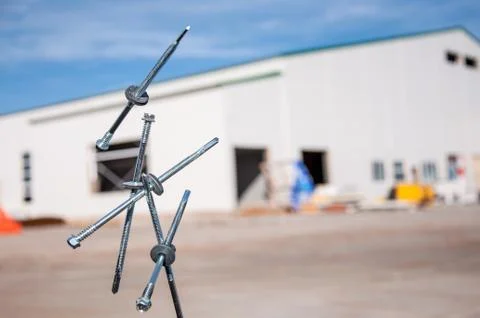 Self-tapping screws falling into the air for sandwich panels. Stock Photos