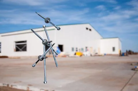 Self-tapping screws falling into the air for sandwich panels. Stock Photos