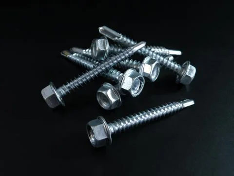 Self-tapping screws galvanized with a semicircular head and a hex head on a Stock Photos