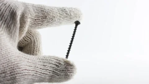 Self-tapping screws isolated. A gloved hand holds a self-tapping screw. Stock-Footage 206251041