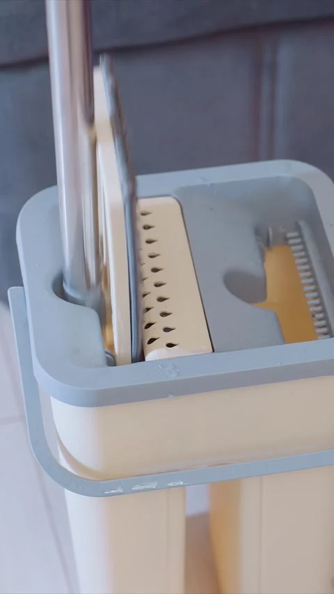 Self Wring Mop Wringer in Action Close Up of Water Drip and Cleaning Tool Detail Stock Footage 346788081