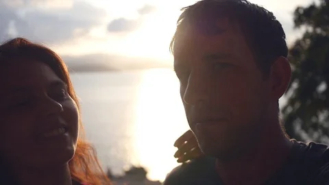 Selfi couple in love on a sunset background at the sea, with sun rays. slow Stock Footage 88399985