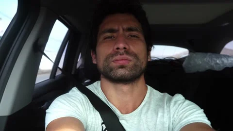 Selfie of bearded white man in road trip car looking at camera in daytime in 4k Stock Footage 172267201