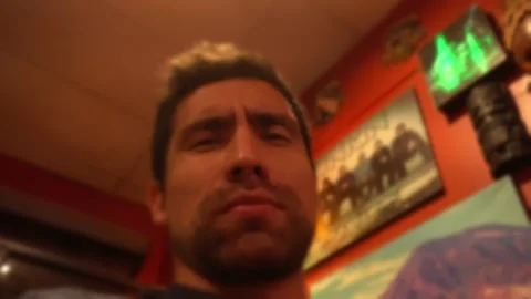 Selfie close-up of a man talking to the camera a little drunk in a bar at night Video stock 196737106