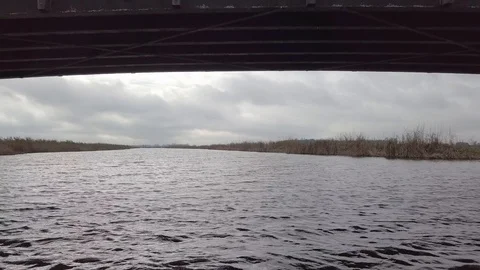 Selfie drone shot of three guys on a bridge over the river Stock Footage 89783182