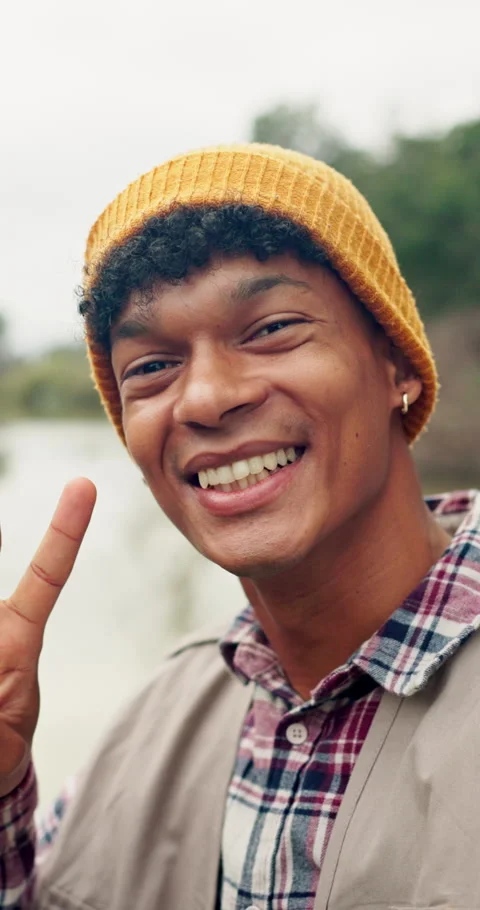 Selfie, happy and face of man in nature with peace sign on vacation, holiday or Stock Footage 335938538