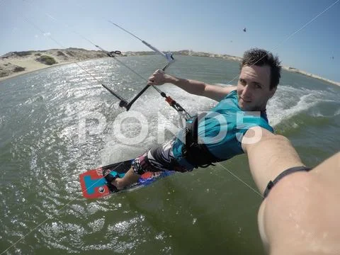 SELFIE: Kiteboarder riding in flat lagoon in Brazil Stock Photos