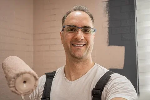 Selfie of Man Smiling While Holding a Paint Roller. Stock Photos