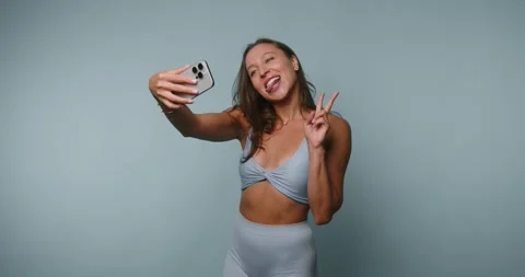 Selfie session with a woman in a studio while smiling and enjoying her time.. Stock-Footage 331990219