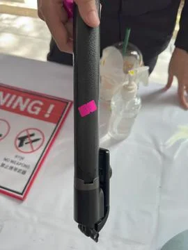 A selfie stick with a numbered sticker at the security checkpoint Stock-Fotos