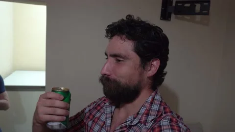 Selfie of a white man with a beard talking to the camera with a beer in his hand Stock Footage 170013420