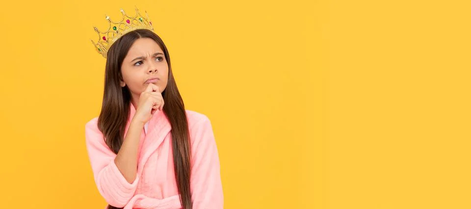 Selfish thoughtful teen girl in home terry bathrobe and princess crown, ego Stock Photos