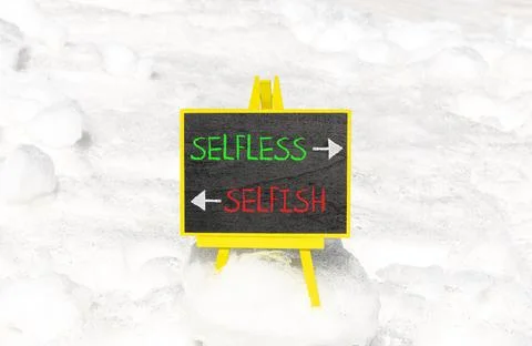 Selfless instead selfish words symbol. Concept words Selfless Selfish on be.. Fotos de archivo