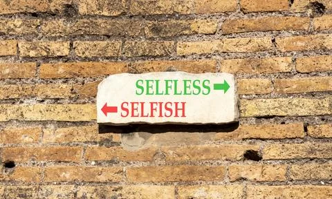 Selfless instead selfish words symbol. Concept words Selfless Selfish on be.. Fotos de archivo