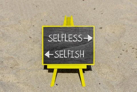 Selfless instead selfish words symbol. Concept words Selfless Selfish on be.. Fotos de archivo