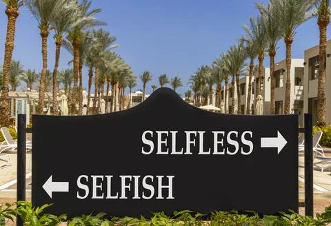 Selfless instead selfish words symbol. Concept words Selfless Selfish on be.. Фото