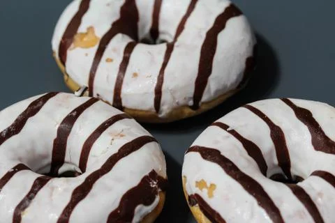 Selfmade vanilla donuts on table. The donuts have white glaze with brown choc Foto stock