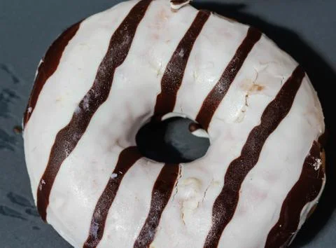 Selfmade vanilla donuts on table. The donuts have white glaze with brown choc Stock Photos
