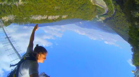 Selfy jump over a mountain gorge with a suspension bridge 69 m Stock Footage 42861814
