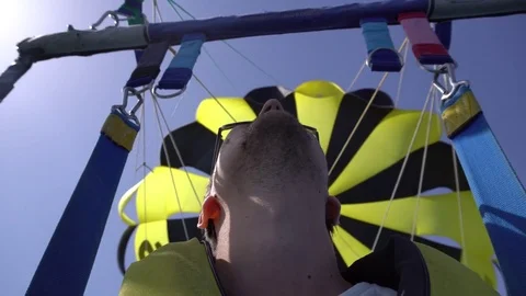 Selfy of screaming and smiling man while parascending with yellow and black Stock Footage 79066629