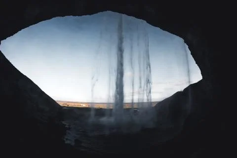 Seljalandsfoss view from inside in evening light before sunset, Iceland. Stock Photos