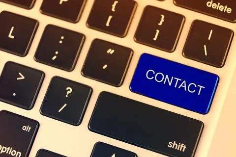 Sell blue button on the keyboard close-up. Conceptual symbol stating Contuct US. Stock Photos