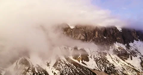Sell hidden in the clouds. Mountains in spring in the Dolomites. Aerial Alpine Stock Footage 132112043