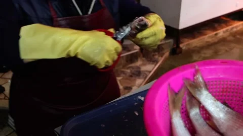 Seller cuts fish with scissors Stock Footage 205467716
