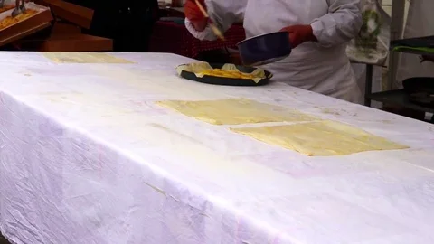 The seller at the fair makes an apple pie in front of the audience. Stock Footage