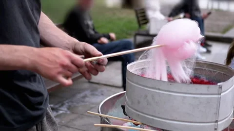 Seller Makes Cotton Candy, a Machine for Making Cotton Candy on the Street Stock Footage 283674245