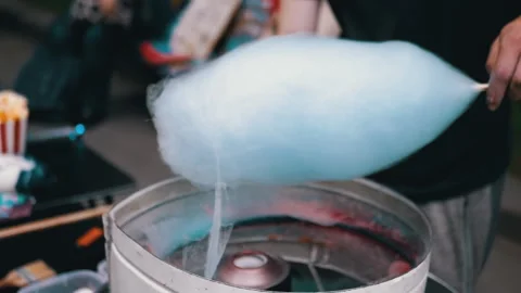 Seller Makes Cotton Candy, a Machine for Making Cotton Candy on the Street Stock Footage 283674384