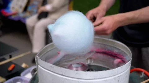Seller Makes Cotton Candy, a Machine for Making Cotton Candy on the Street Stock Footage 283674429
