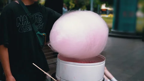 Seller Makes Cotton Candy, a Machine for Making Cotton Candy on the Street Stock Footage 283674483