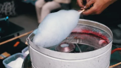 Seller Makes Cotton Candy, a Machine for Making Cotton Candy on the Street Stock Footage 293166005