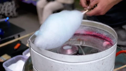 Seller Makes Cotton Candy, a Machine for Making Cotton Candy on the Street Stock Footage 293166470