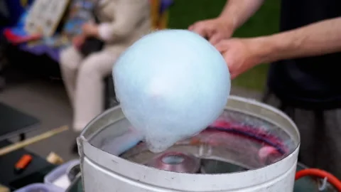 Seller Makes Cotton Candy, a Machine for Making Cotton Candy on the Street Stock Footage 293173295