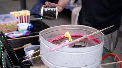 Seller Makes Cotton Candy, Machine for Making Cotton Candy on the Street Stock Footage 293173555