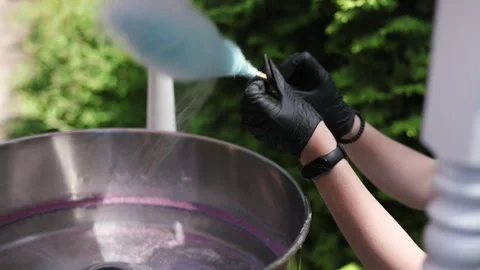 Seller Makes Cotton Candy, a Machine for Making Cotton Candy on the Street. Stock Footage 310482969