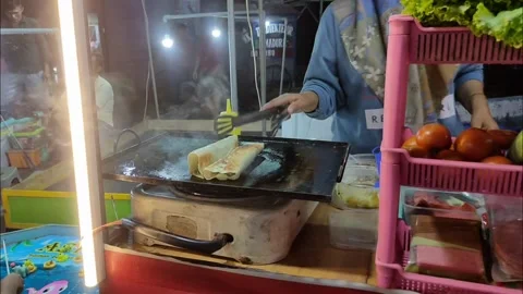 The seller prepares kebabs for his customers Stock Footage 228704953