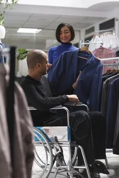 Seller showing jacket to client Stock-Fotos