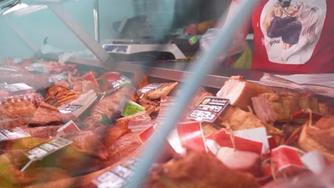 The Seller takes the meat from the window to serve to the customer. Close-up Stock Footage 132881157
