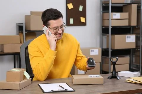 Seller talking on phone while working in office. Online store Photos