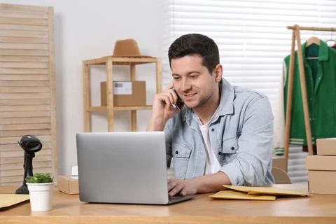 Seller talking on phone while working in office. Online store Photos