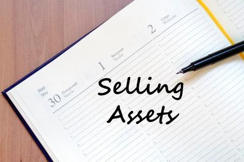 Selling assets write on notebook Stock Photos