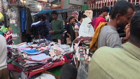 Selling Export T-Shirts and Local Kids’ Pants in Front of Dhaka New Market Video stock 323901034