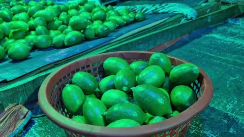 Selling Green Lemons Under Artificial Green Lighting In Vegetable Market 動画素材 336647182