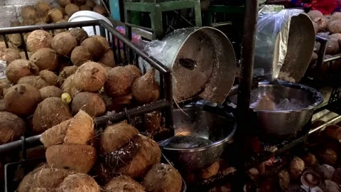Selling Old Coconut with Grinder Machine in the Market Stock Footage 233976420